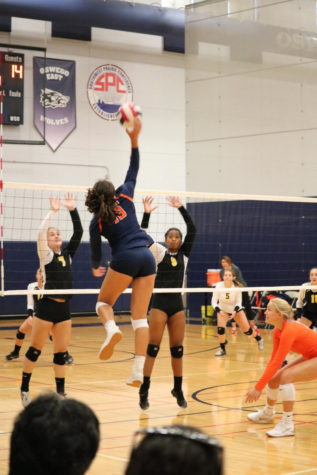 Senior Mireya Garcia leaps to spike a ball.