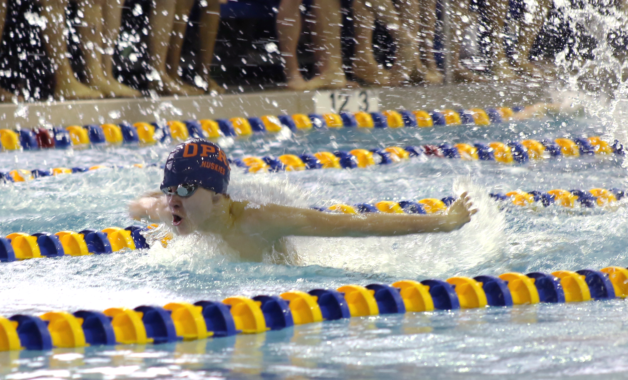 Sophomore Will Vejcik swims down the pool during a competition.