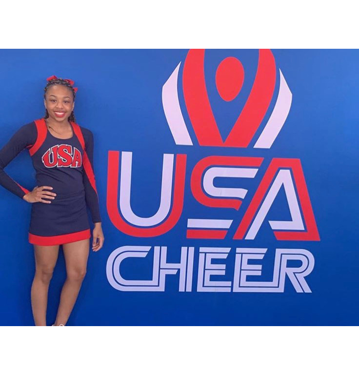 Iry Conley in front of USA Cheer sign