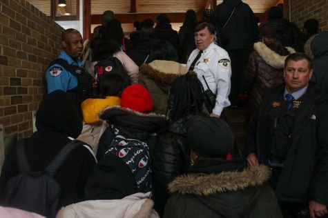 Students march past Oak Park police officers during their walkout Wednesday morning