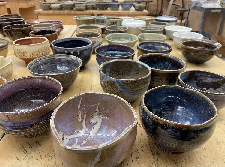 Students distribute handmade bowls at Empty Bowls 2021. Local studios Terra Incognito (246 Chicago Ave.) and ViaClay (208 S. Marion St.) helped with bowl production.