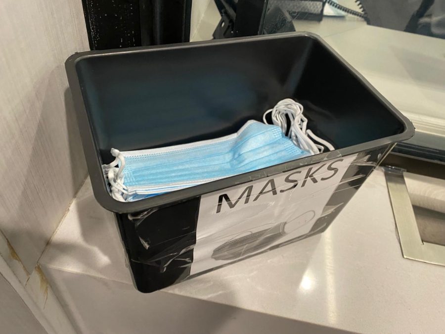 A bin of now-optional masks sits in the welcome center