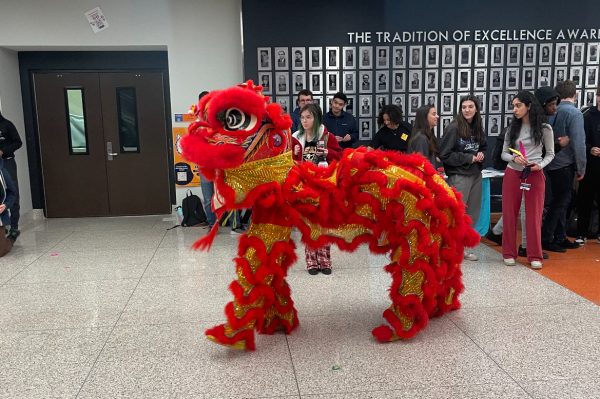 Students watch as the Lunar New Year dragon makes its way through the commons.