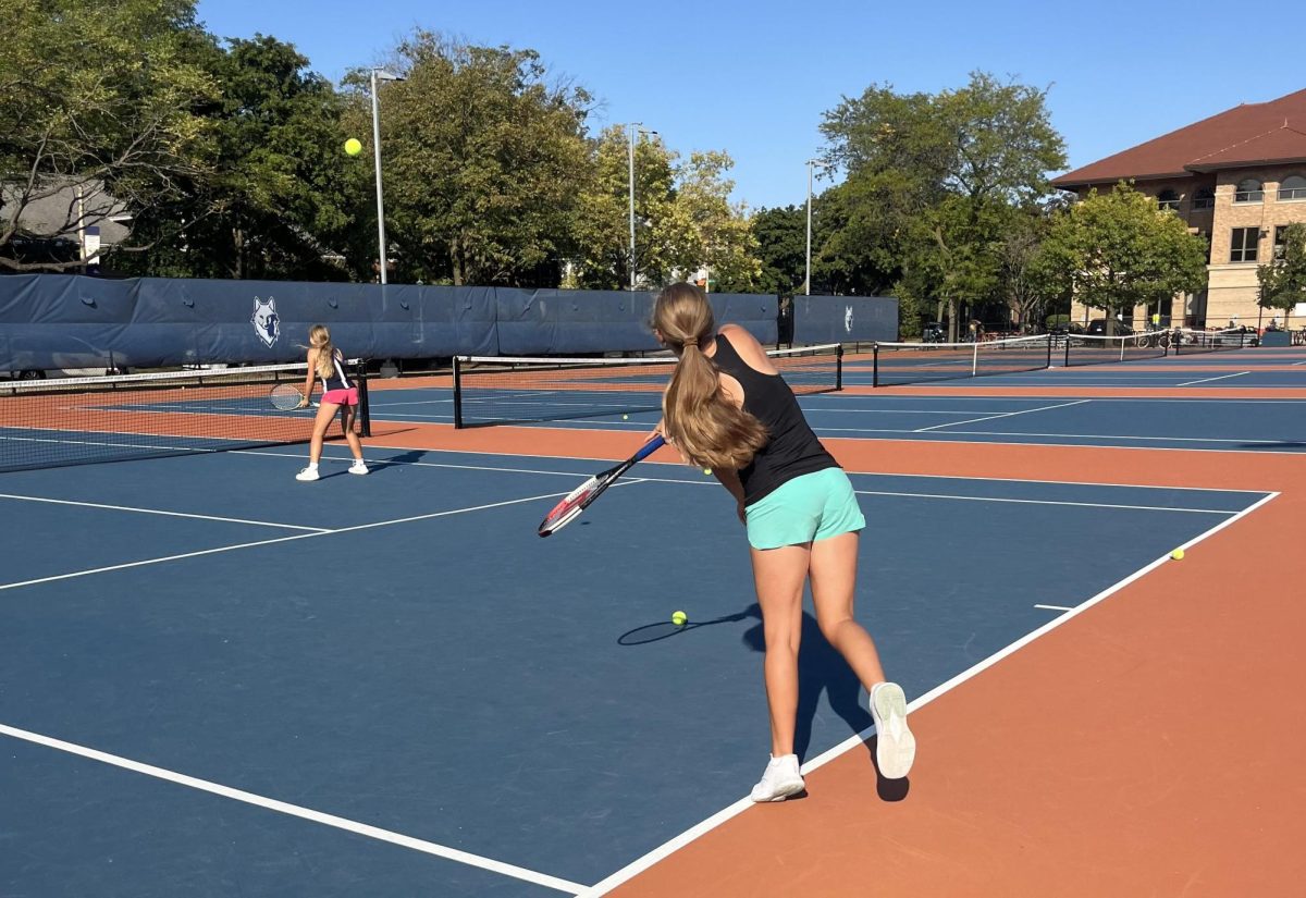 Sophomores Abigail Turnock and Elizabeth Stine practicing their swing.