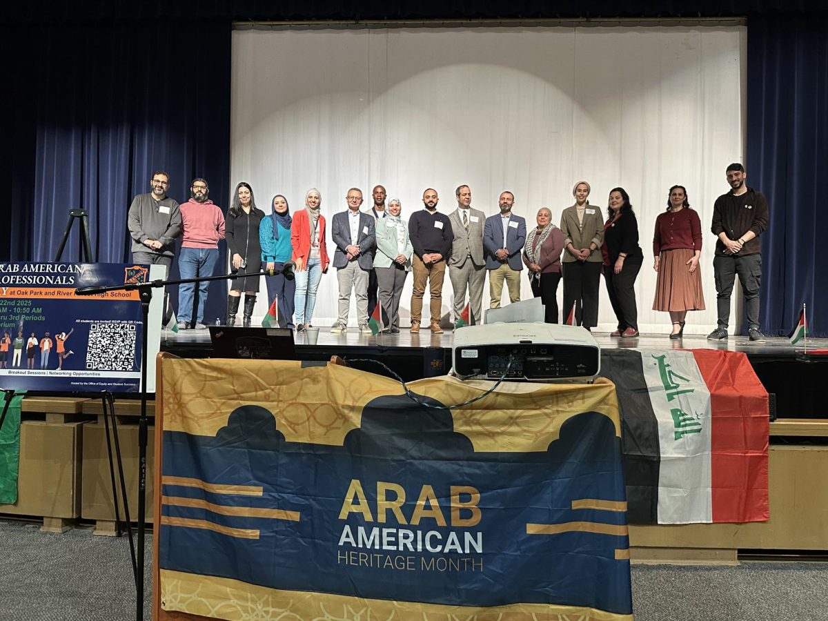 Guests at Arab-American Professionals Day line up onstage in the auditorium on April 22. 