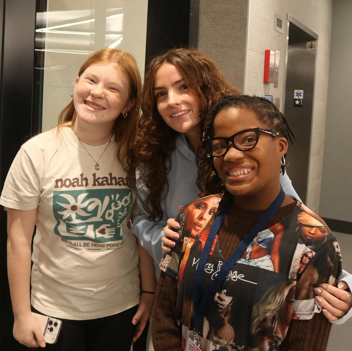 Hailey Boland (center) smiles with other Best Buddies members (left and right)