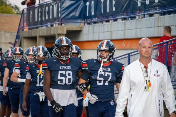 Head Coach John Hoerster on the field with the football team in September