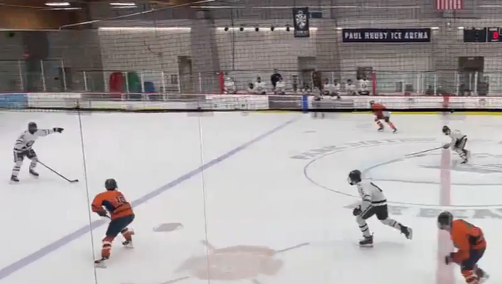 Senior Jackson Schott chases the puck on his way to scoring for the Huskies at the Jan. 17 game against Mount Carmel.