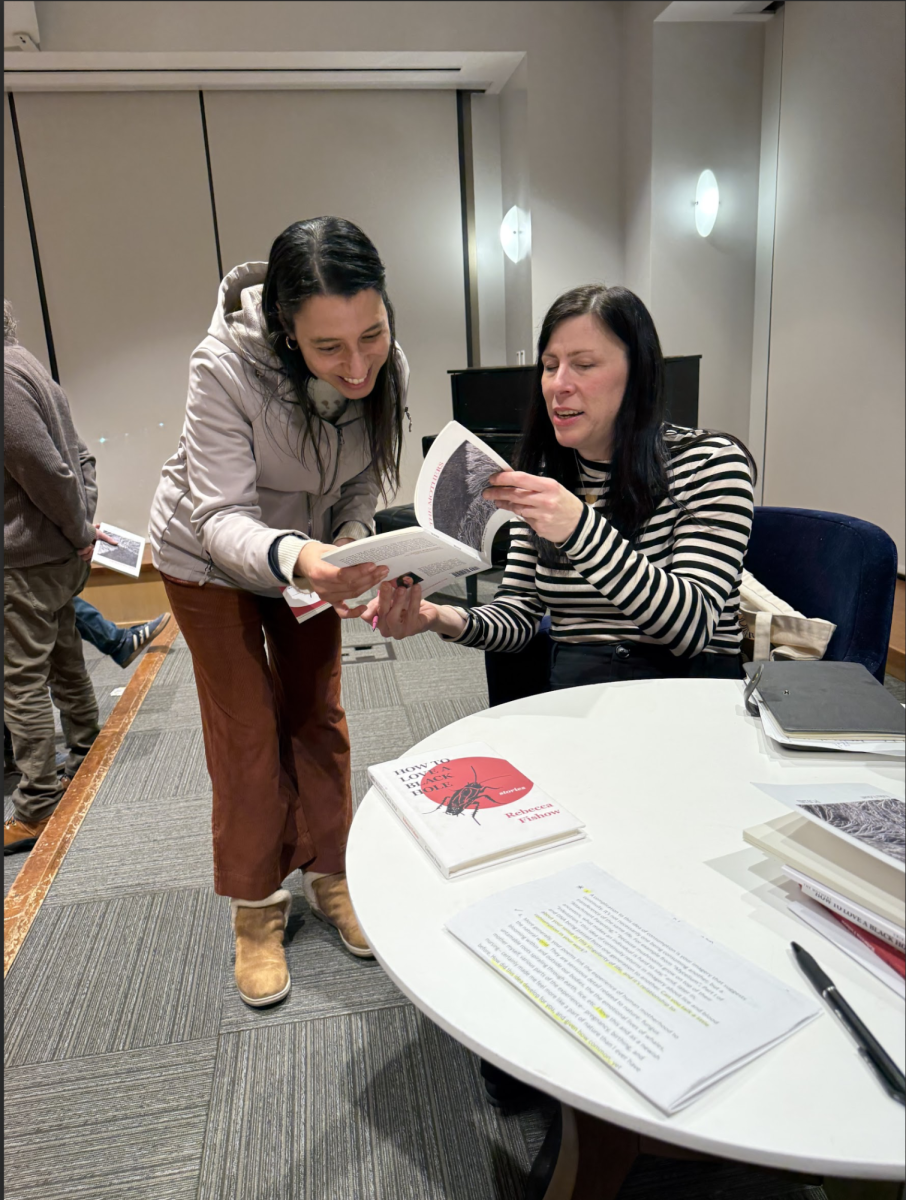 Erika Eckart signing her poetry book for a reader at the Oak Park Public Library. 
